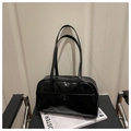 Close-up of black glossy leather handbag with double handles on minimalist background - Black Without Pendant