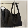 Detail of black nylon tote bag with drawstring closure and wide shoulder strap texture - No Pendant / Black