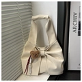 Detail of cream bow tote bag with plush bear charm and woven rope accessory - White With Pendant