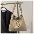 Detail of beige nylon crossbody bag featuring drawstring closure and black strap - No Pendant / Khaki