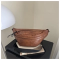Detailed view of the brown leather texture and zipper closure on the vintage chest bag - Coffee