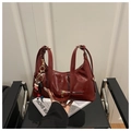 Deep red vintage tote bag in glossy leather finish with adjustable strap and bull charm - Red