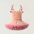 Detail of peach pink tutu dress featuring tiered mesh layers and ribbon shoulder straps - XL (130cm) / Tops / Peach Coral
