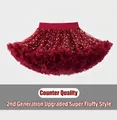 Detail of red tutu skirt featuring gold star patterns and a comfortable elastic waistband - S / Wine Red With Stars