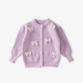 Close-up of lavender knit cardigan for girls featuring pearl buttons and lace bows - 120cm / Purple Knitted Cardigan