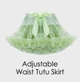 Detail of light green tutu skirt featuring layered mesh and adjustable silk bow waistband - Avocado Green
