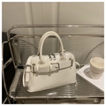 Chic white patent leather Boston bag with belt buckle detail and dual silver zippers - White