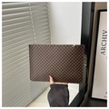 Detail of coffee brown quilted makeup bag with retro patterns and gold zipper - Monogram Coffee