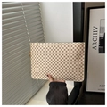 Detail of a creamy white textured clutch bag with reddish monogram and gold zipper closure - Monogram White