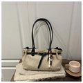 Detail of beige matte tote bag with black leather straps and decorative beaded charm - With Pendant / Khaki