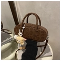 Detail of vintage leopard print suede cylinder bag with a cute plush monster charm - Brown with Pendant