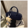 Detail of navy blue suede bowling bag with monster charm and silver hardware accents - Blue With Charm