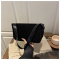 Detail of black suede shoulder bag featuring magnetic flap and silver buckle hardware - Black