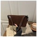 Close-up of vintage brown frosted texture underarm bag with silver metal buckle details - Brown