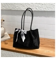 Detail of a black suede tote bag with a vintage printed silk scarf on a wooden surface - Black