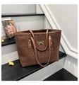 Detailed view of leopard print tote bag with gold bow ornament and slim handles - Coffee