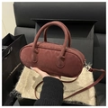 Dark red faux suede baguette bag with dual handles and metal strap on gift packaging - Red Without Charm