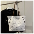 Borsa tote in tela bianca con manici in pelle marrone e illustrazioni di cartoni animati - Bianco