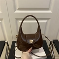 Brown patent leather crescent bag with golden lock and shoulder strap in high gloss - Brown