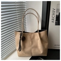 Macro detail of khaki suede tote bag featuring long shoulder straps and tassel charm - Khaki With Pendant