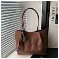Detail of dark brown suede tote bag with woven pendant charm and slim shoulder straps - Coffee with Pendant