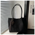 Detail of a black large-capacity tote bag with suede texture and woven strap charm accessory - Black With Pendant