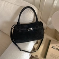Detailed close-up of a black suede bucket bag with silver buckle and adjustable shoulder strap - No Pendant / Black