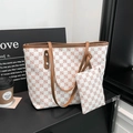 Chic checkered tote bag with matching pouch and brown leather trim in a stylish setting - White