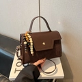 Vintage brown crossbody bag featuring mixed textures and multi-colored wooden bead charm - With Pendant / Brown