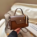 Brown faux leather crossbody bag with suede panels and decorative beaded pendant - With Pendant / Brown