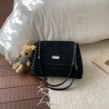 Minimalist black velvet crossbody bag with chain strap and cute bear charm in cozy room - Black