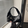 Sleek black high-gloss leather hobo bag with unique twisted knot handle design - Black