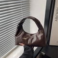 Dark brown high-shine patent leather tote bag with pleated handle in a hobo design - Brown