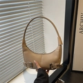 Minimalist beige moon bag in matte leather featuring decorative metal buckle straps - Khaki