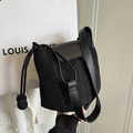 Minimalist black square bucket bag in canvas and leather with unique ball tassel detail - Black