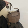 Minimalist dark brown suede crossbody bag with spherical pendants on leather sofa - Brown