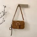 Detail of dark brown suede crossbody bag with gold buckle and baseball charm - With Pendant / Brown