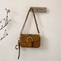 Detail of dark brown suede crossbody bag with gold buckle and baseball charm - With Pendant / Brown