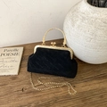 Detailed view of black velvet handbag with gold metal frame and rich rabbit pattern - Black