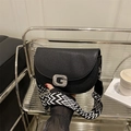 Chic black leather saddle bag with silver diamond G-buckle and woven shoulder strap - Black