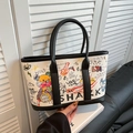 Chique beige canvas tote bag met levendige streetstyle graffiti en zwarte lederen trim - Zwart