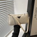 Chic cream nylon underarm bag with metal logo and sleek minimalist shoulder strap - White