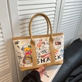 Beige canvas tote bag with trendy graffiti patterns and stylish brown leather trim - Khaki