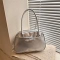 Silver metallic underarm bag featuring a delicate bow decoration and dual long handles - Silver