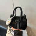 Matte black bucket bag with white stitching detail and a cute plush charm accessory - With Pendant / Black