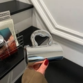 Futuristic silver cylindrical handbag with a metallic mirror finish and thin chain strap - Silver