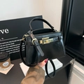 Classic black patent leather crossbody bag with a gold metal lock and adjustable strap - Black