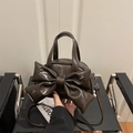 Dark brown leather square bag featuring a large bow and silver star metal studs - Brown