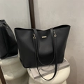 Minimalist black matte leather tote bag with elegant rectangular metal buckle and slim straps - Black