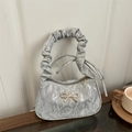 Chic silver shoulder bag with golden bow accent and ruffled cloud-like handle detail - Silver